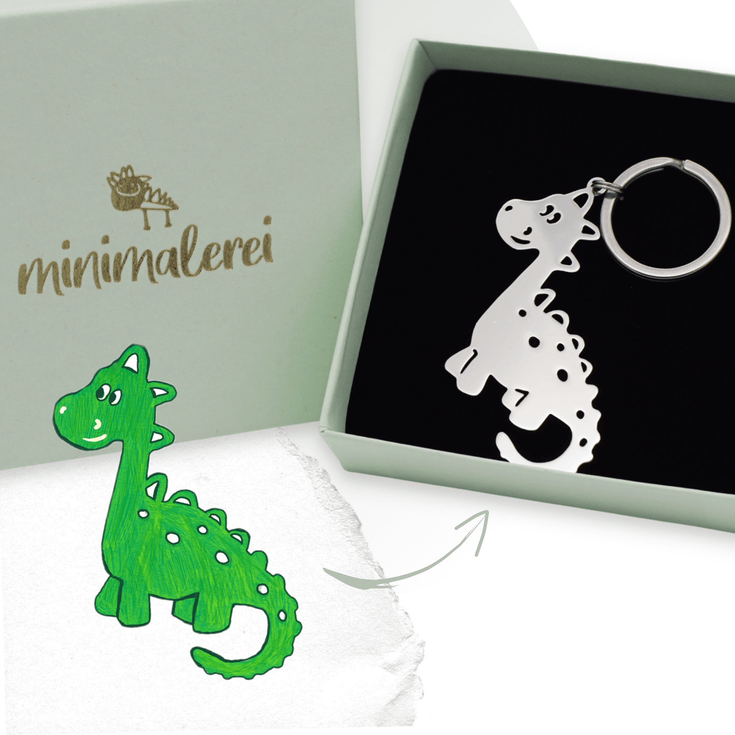 Grüner Dino aus Kinderzeichnung als silberner Anhänger in Minimalerei-Geschenkbox